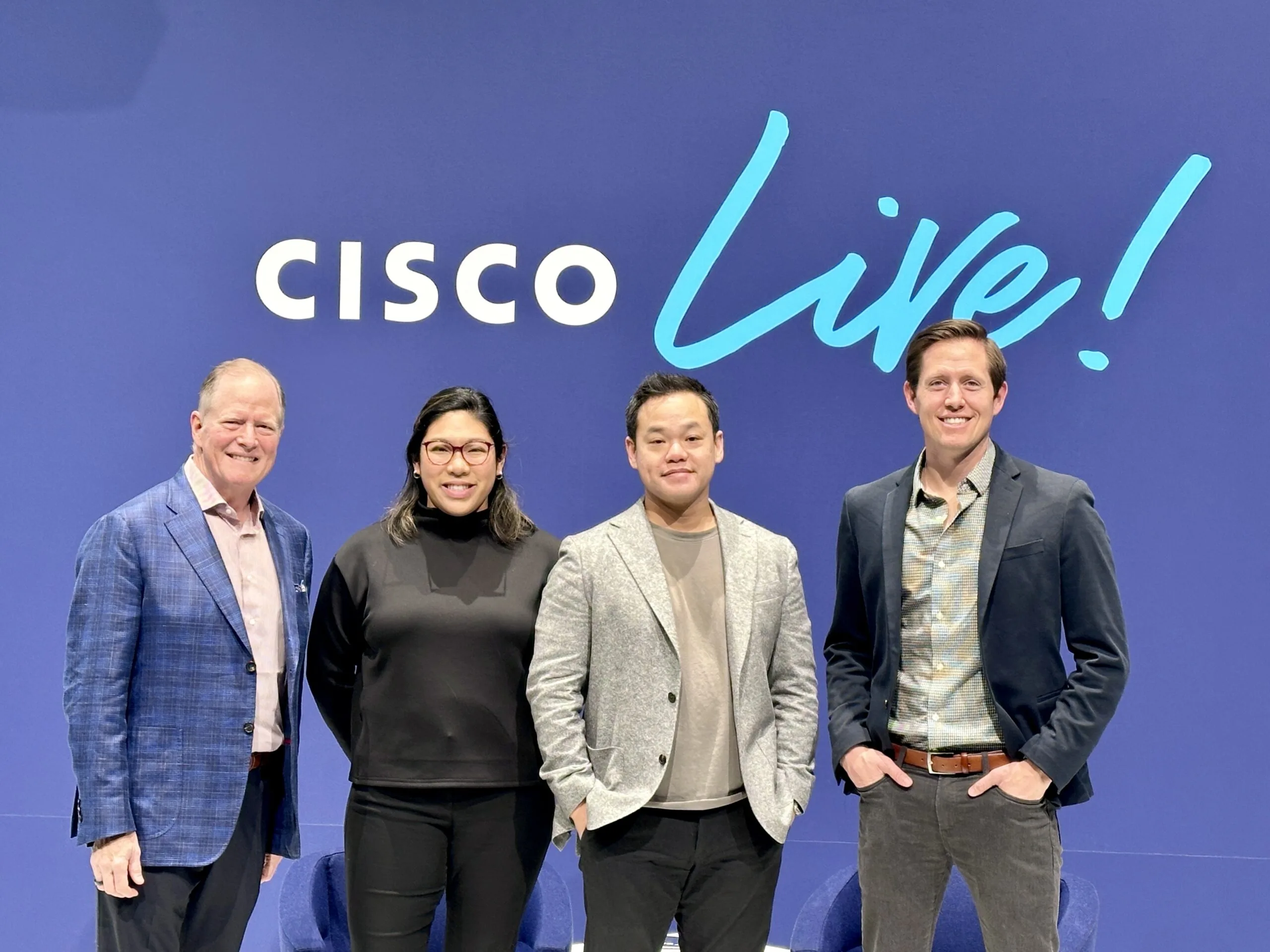 Journey team in front of Cisco Live sign