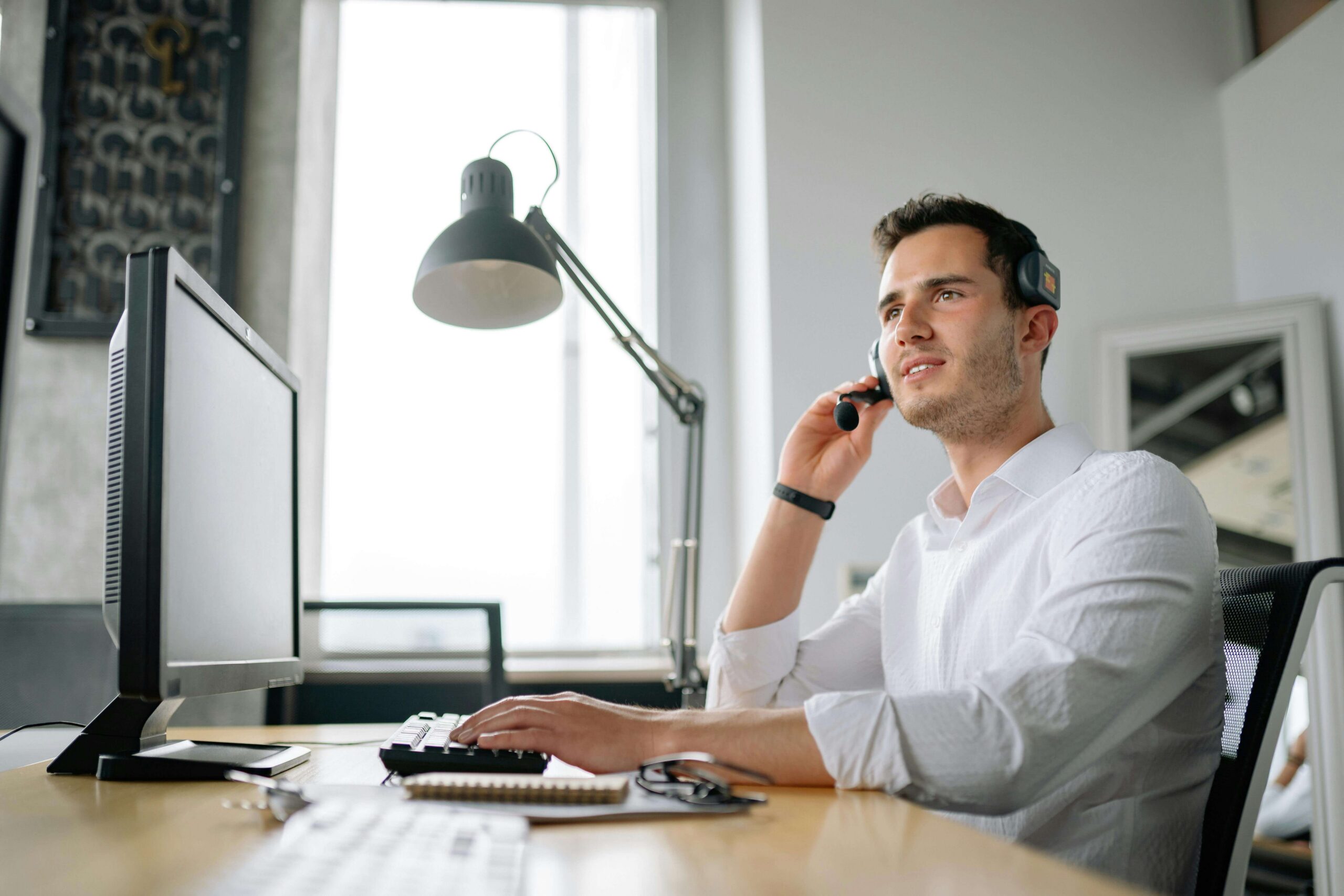 Person sitting at desk in a bright room