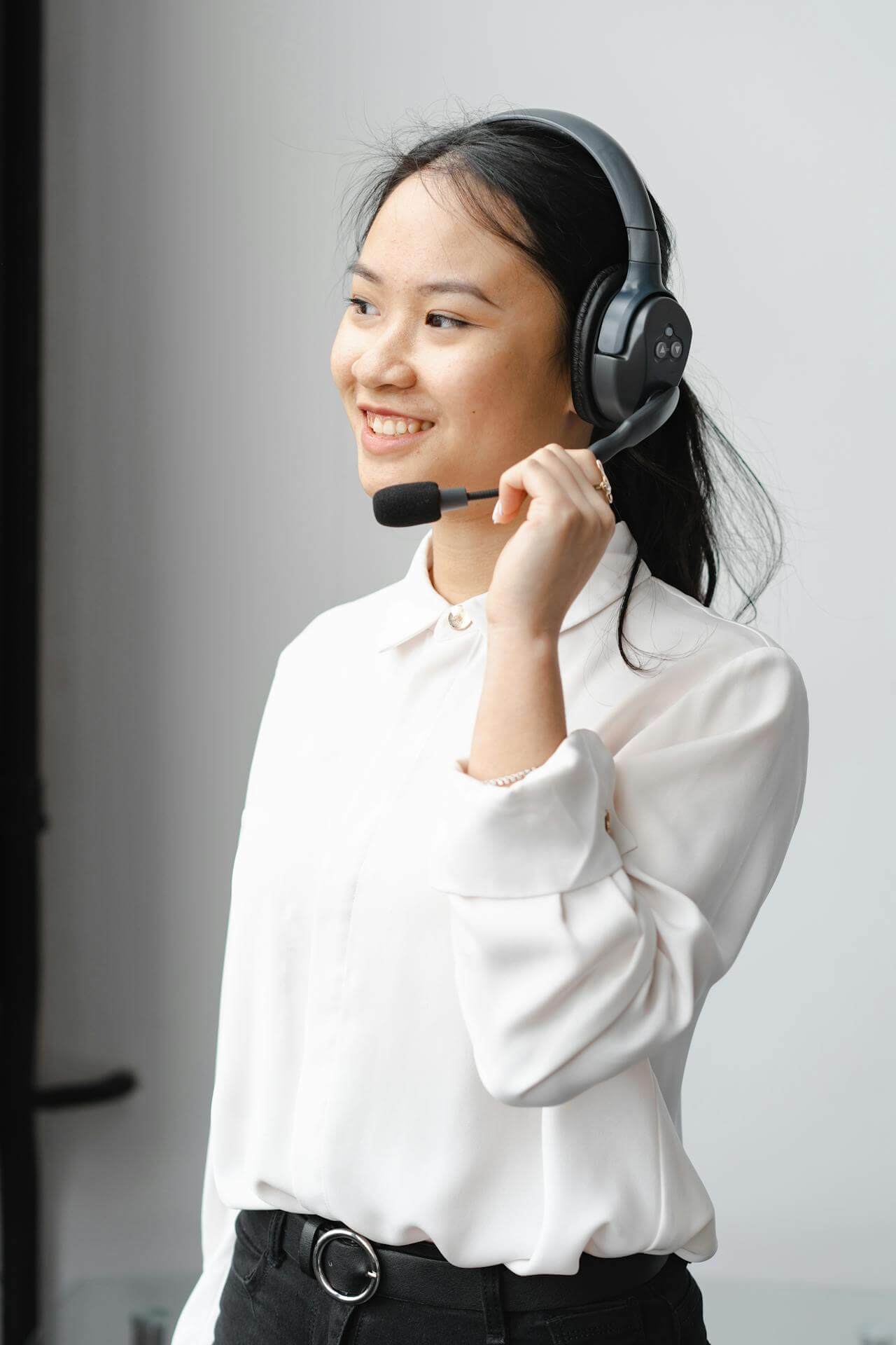 Contact center agent standing in front of white wall
