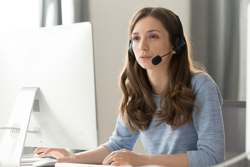 Woman with headset at computer
