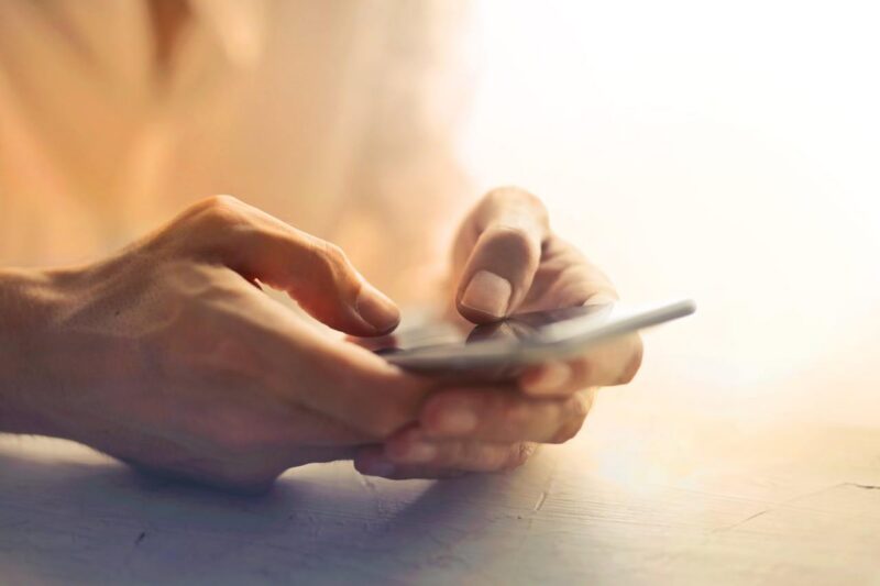 Close up of user typing on phone