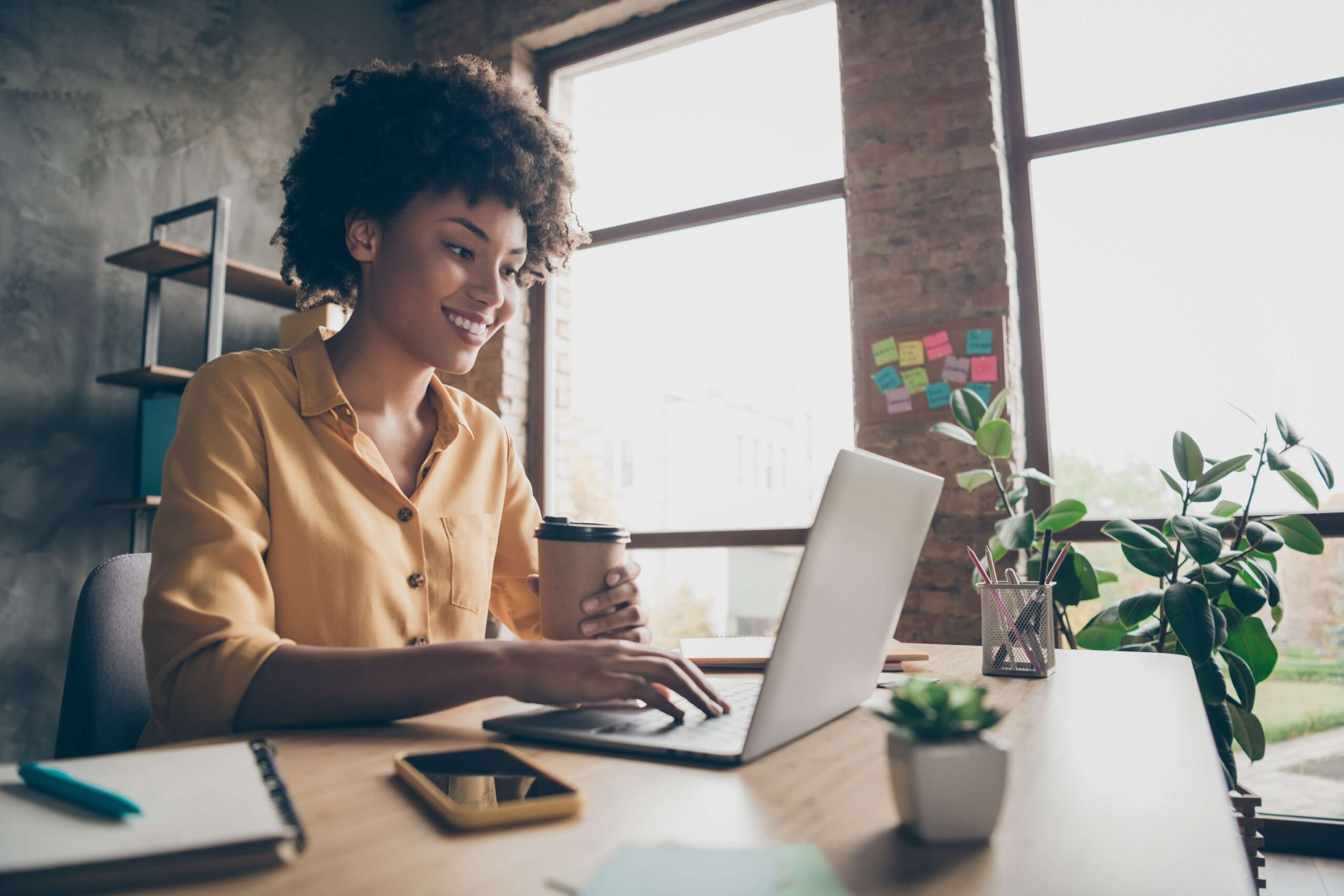 Woman with coffee at computer