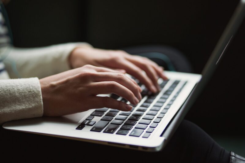 Woman typing on keyboard