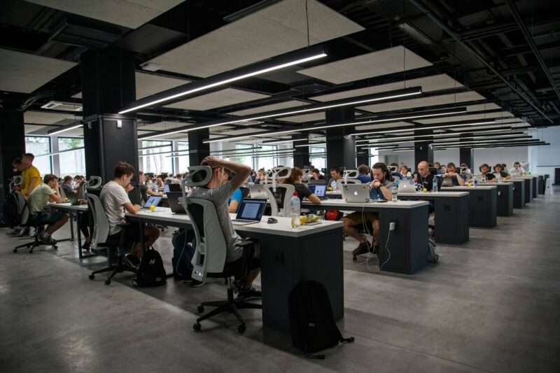 Busy office floor with workers at their coputers