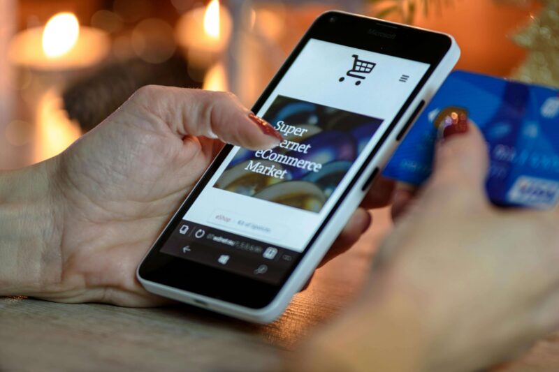 Person using phone to browse retail store
